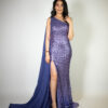 Alt text: "Bright purple gown called Ube, featuring a one-shoulder cape, high slit, full sequins, and a mid-length train, perfect for glamorous occasions."