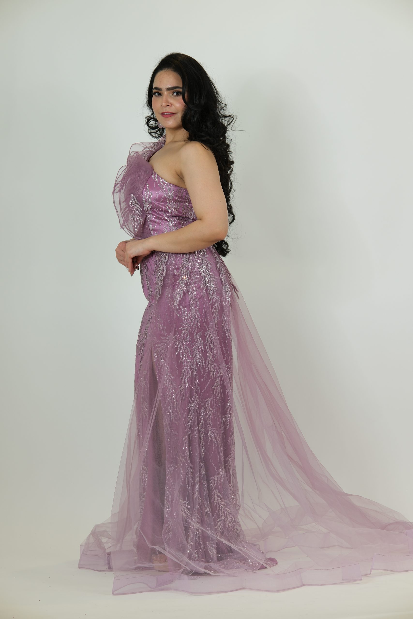 “Mauve sequin one-shoulder gown with tulle drapes and a front slit.”