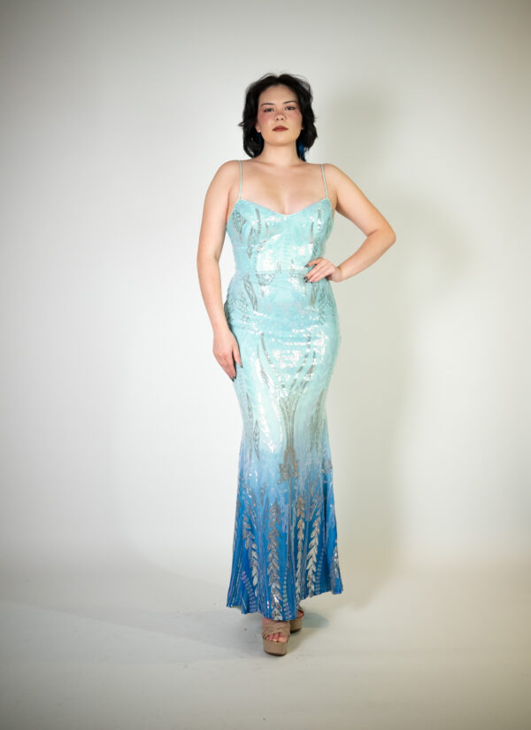 Alt text: "Ombre teal and dark blue evening gown called Aquata, featuring silver sequin details and a corset back, perfect for special occasions."