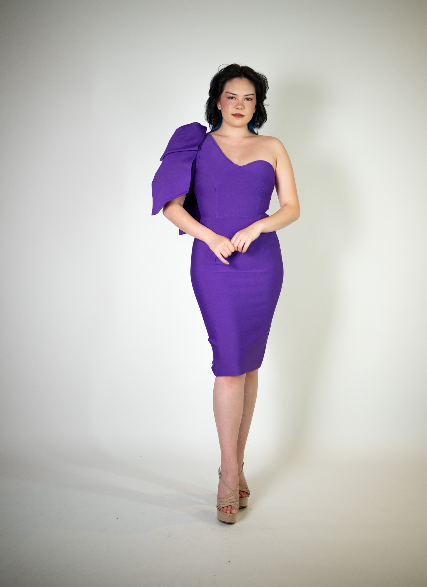 Alt text: "Vibrant purple midi bodycon dress called Fleur, featuring a one-shoulder ruffle detail, perfect for special occasions."