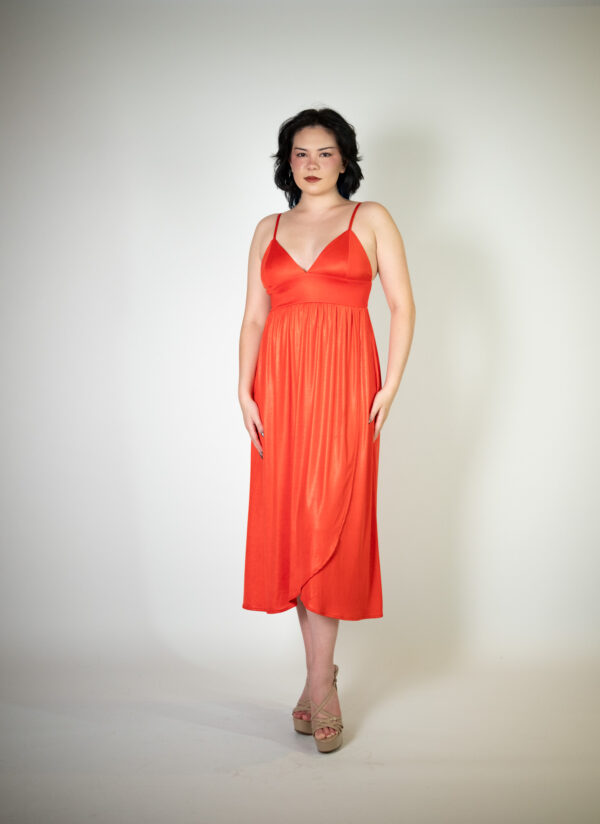 Alt text: "Red-orange midi dress called Elina, featuring a wrap skirt and flowy design, perfect for special occasions."