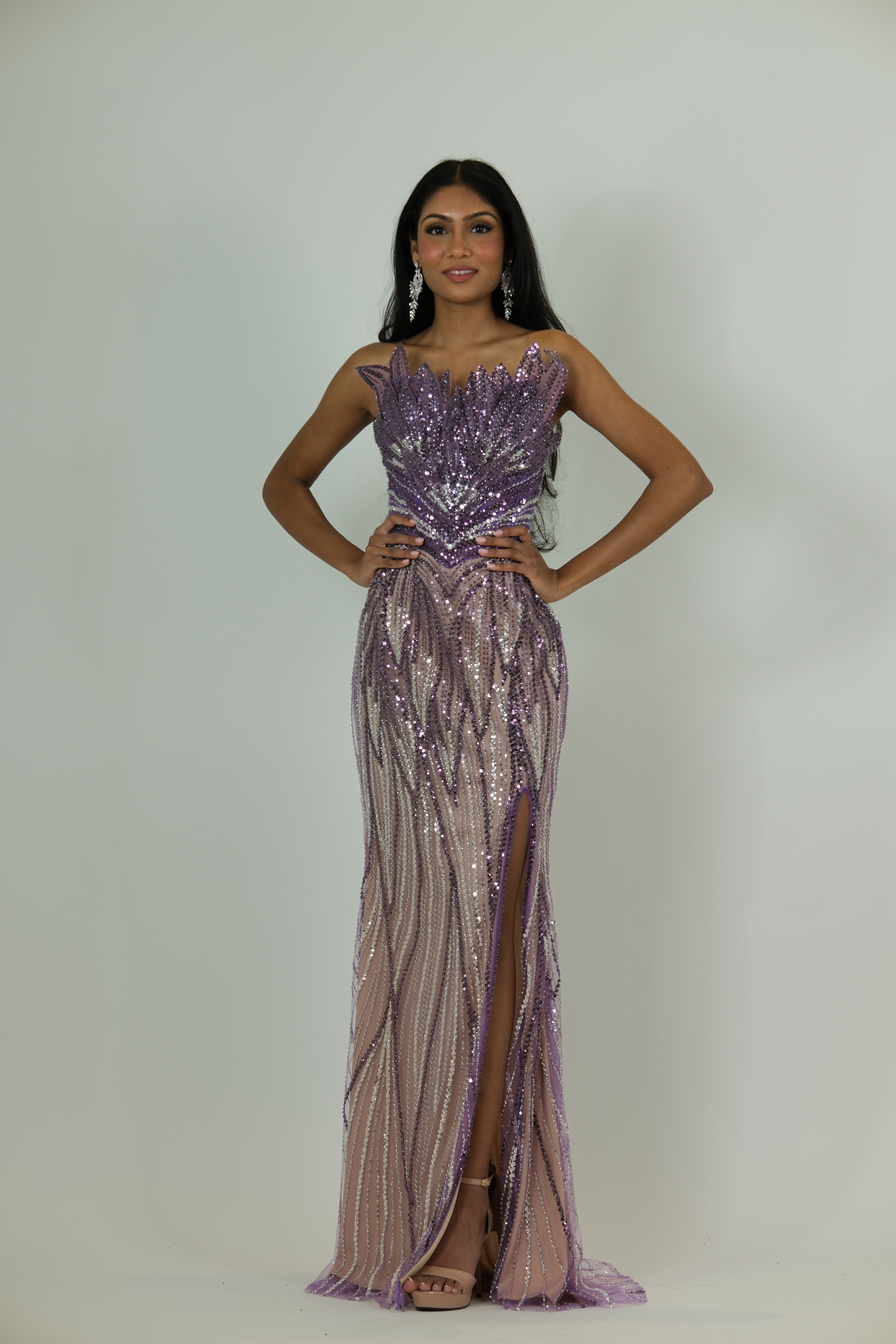 “Purple-pink sequin gown with leaf-patterned bodice and leg slit.”