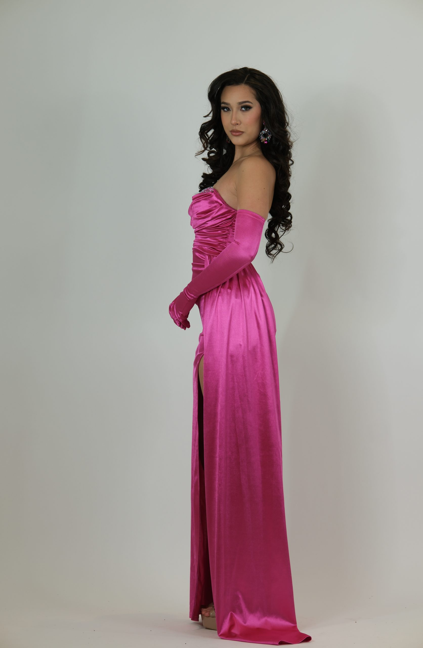 "Hot pink satin evening gown called Calanthe, featuring a strapless draped bodice, high slit, ruched waist, and matching long glove