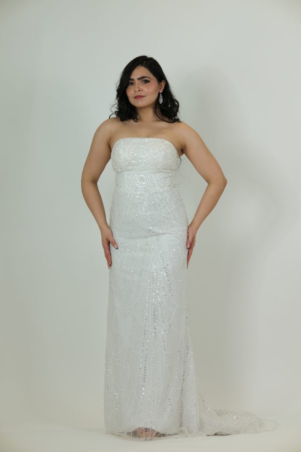 “White strapless beaded gown with full-length sequin detailing and a sleek column silhouette.”