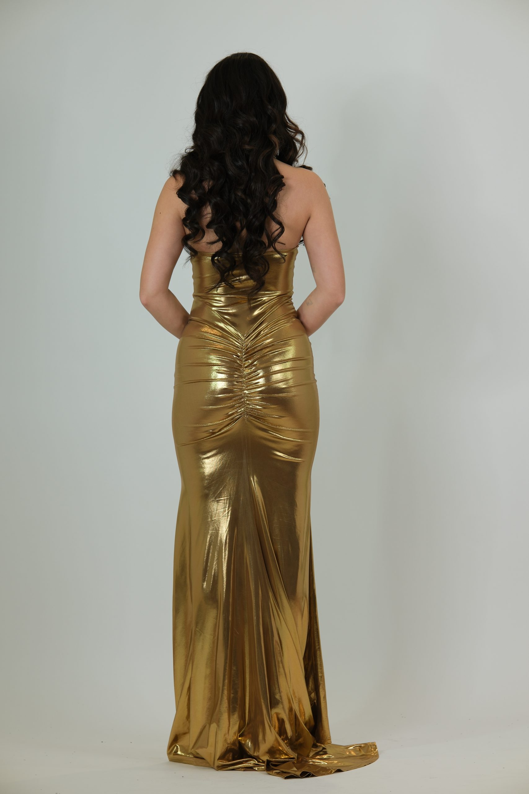 "Metallic gold strapless evening gown with structured corset bodice, ruched waist, and sleek floor-length skirt.