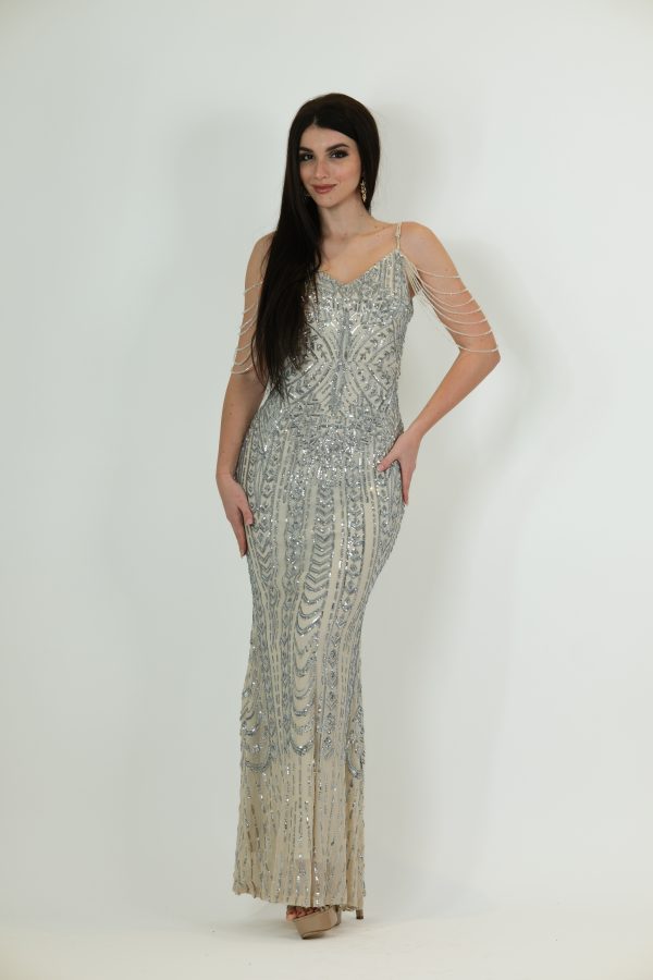 Ivory and silver sequin evening gown called Ivorelle, featuring draped shoulder strands and a fitted floor-length silhouette, perfect for special occasions.