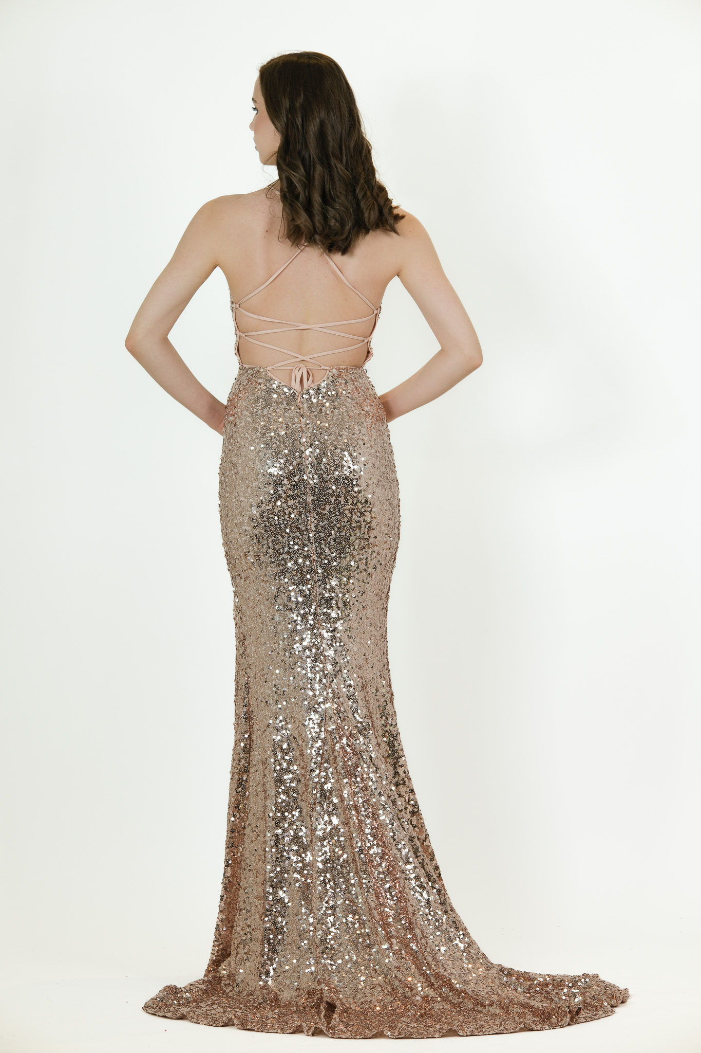 “Rose-gold sequin gown with spaghetti straps and high front slit.”