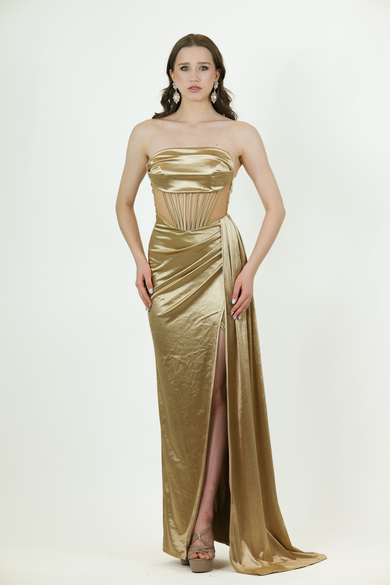 “Gold satin gown with bandeau top, cut-out corset details, draped waist, and high slit.”