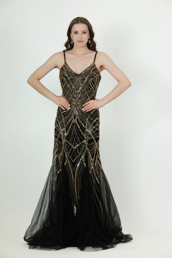 “Black mermaid gown with gold Art Deco beading, delicate straps, and tulle hem.”