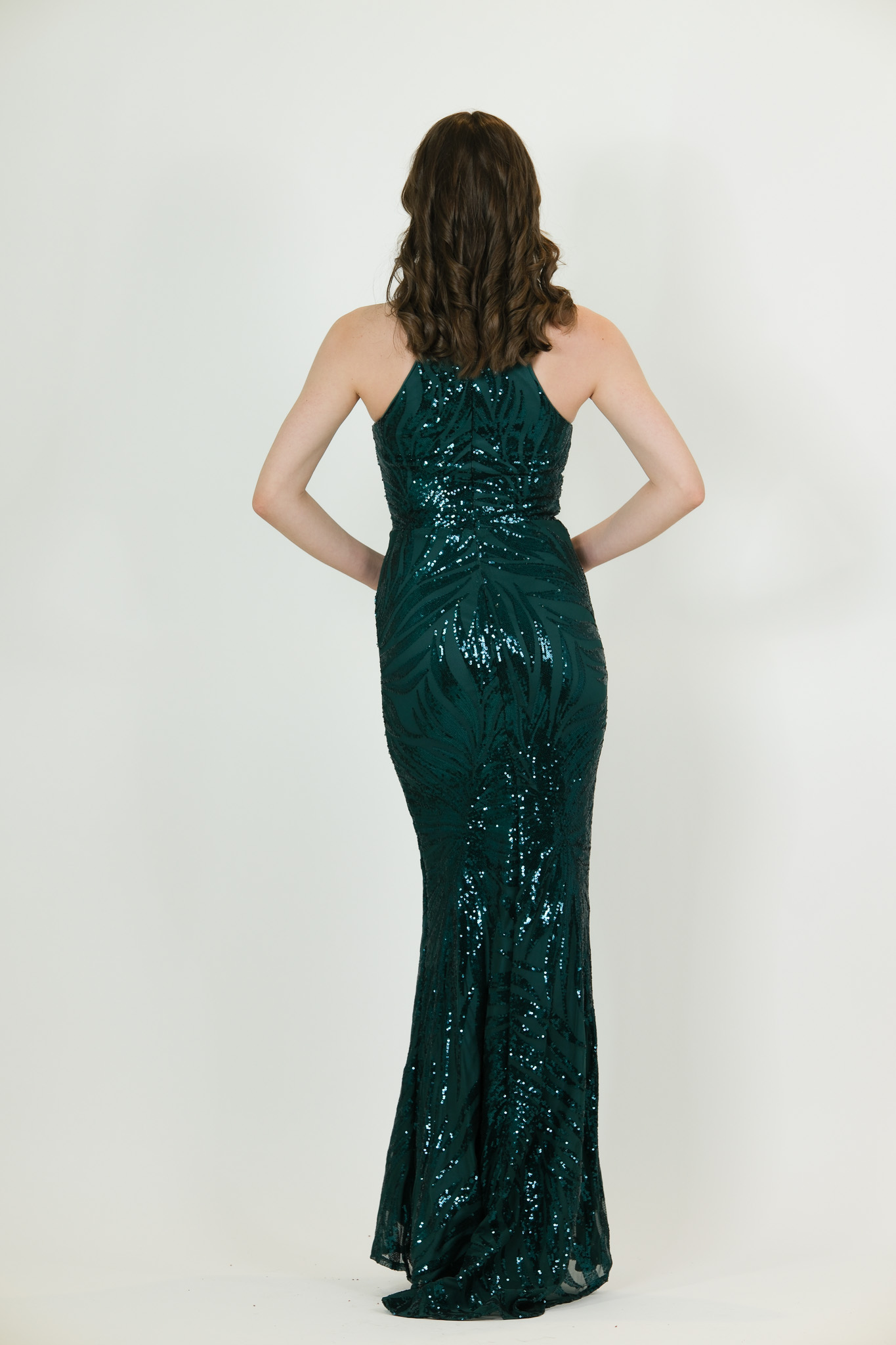 “Emerald green sequin halter gown with front keyhole and fitted silhouette.”