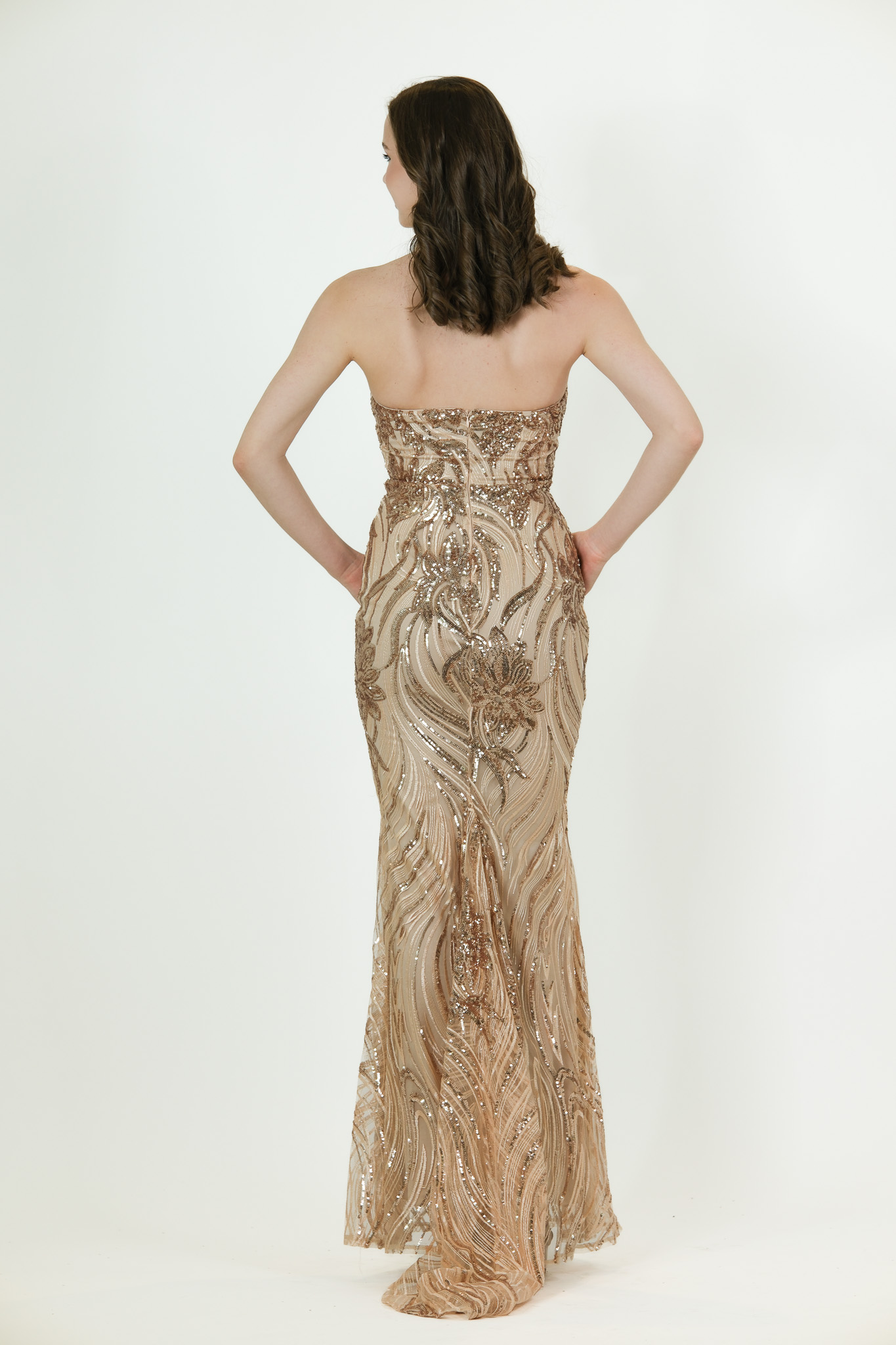 “Gold halter-neck sequin gown with detailed beading and fitted full-length silhouette.”