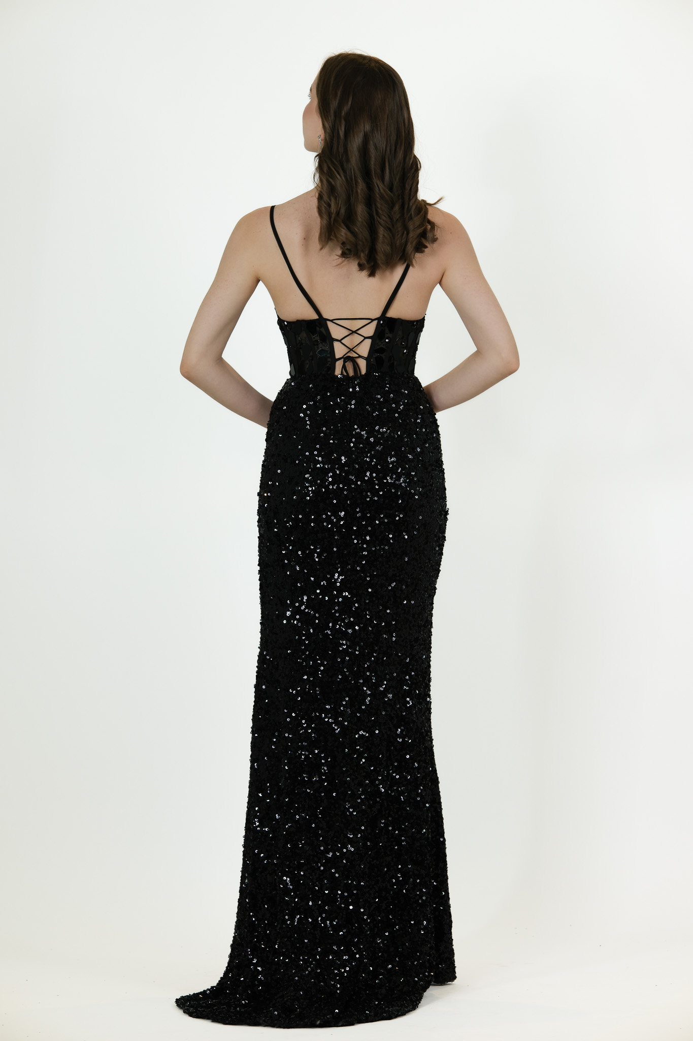 “Black sequin gown with corset-style bodice, thin straps, and front slit.”