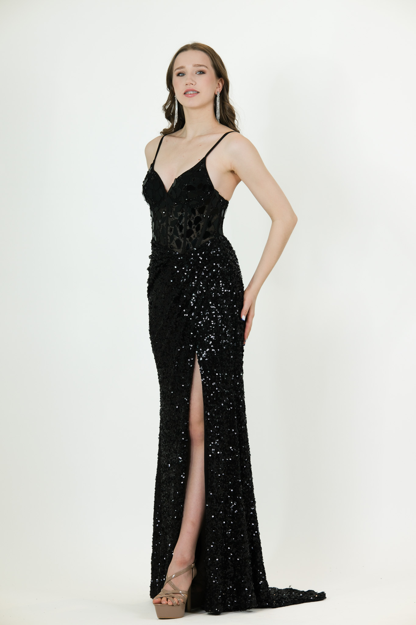 “Black sequin gown with corset-style bodice, thin straps, and front slit.”