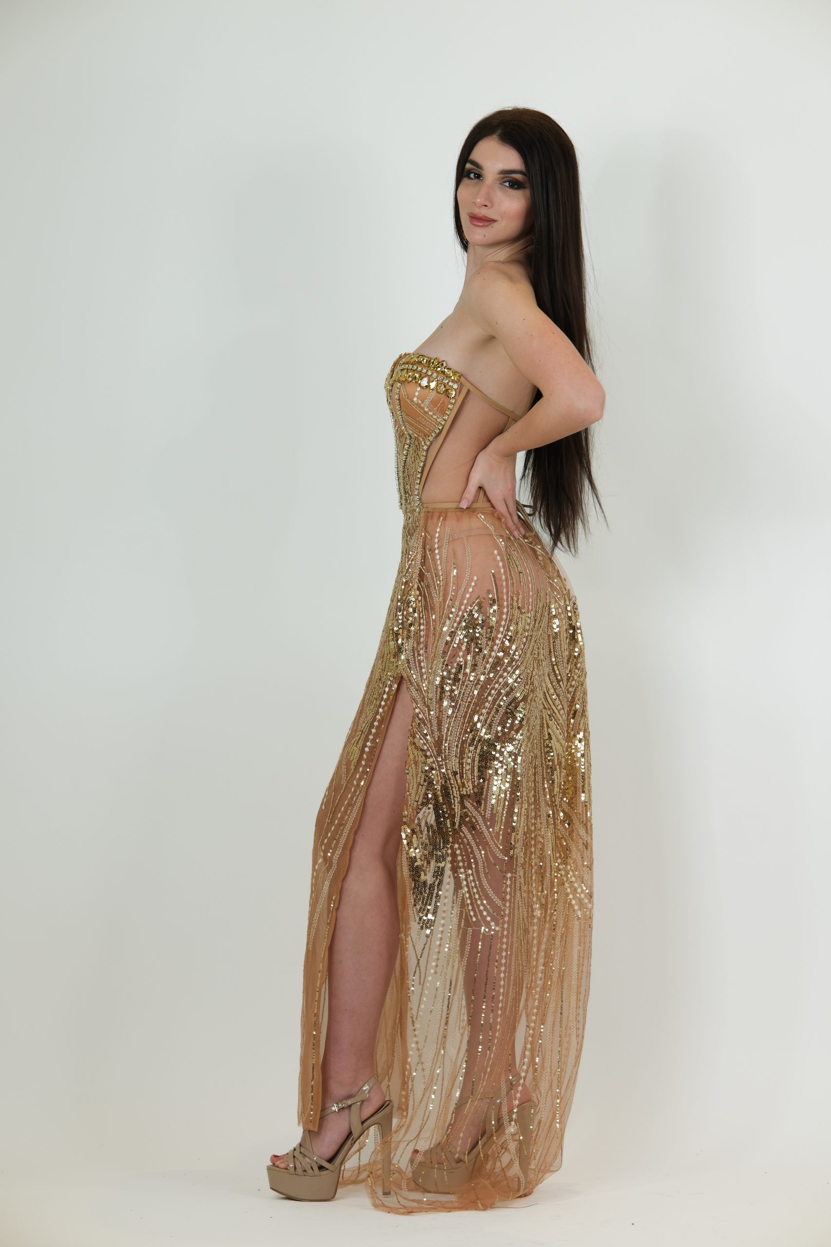 Nude and gold strapless evening gown called Anastasia, featuring a corset-style bodice with gold sequin and bead detailing and a sheer floor-length skirt