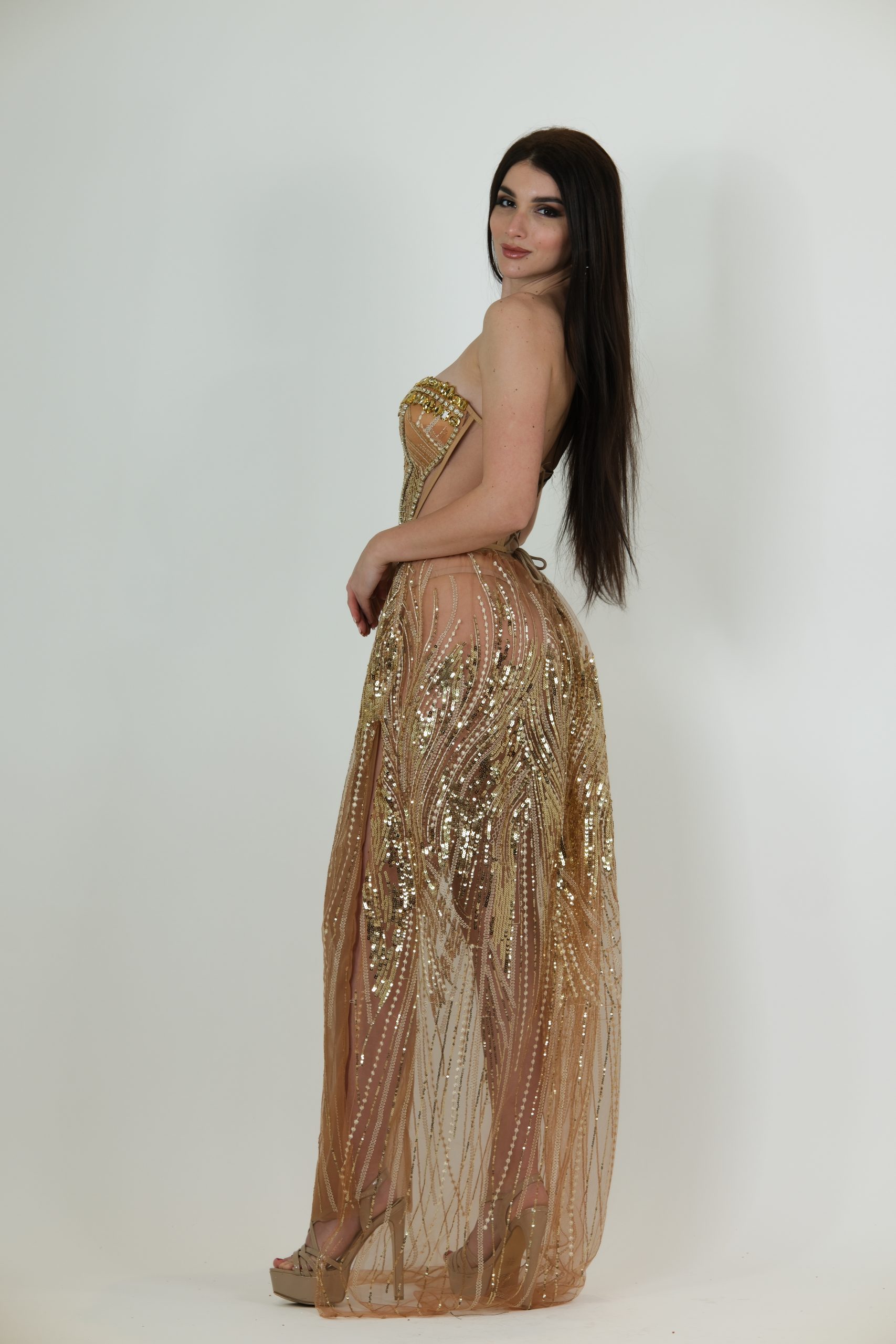 Nude and gold strapless evening gown called Anastasia, featuring a corset-style bodice with gold sequin and bead detailing and a sheer floor-length skirt
